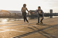 Young couple skateboarding at the riverside - PhotoDune Item for Sale