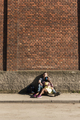 Young couple siting on ground, listening music - PhotoDune Item for Sale
