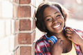Portrait of a happy young woman with headphones around her neck - PhotoDune Item for Sale