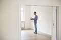 Young man in new home holding plan - PhotoDune Item for Sale