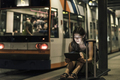 Portrait of young woman waiting at tram stop by night using tablet - PhotoDune Item for Sale