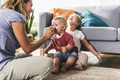 Mother feeding kids in living room - PhotoDune Item for Sale