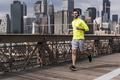 USA, New York City, man running on Brooklyn Brige - PhotoDune Item for Sale
