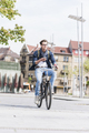 Young man with bicycle in the city holding cell phone - PhotoDune Item for Sale