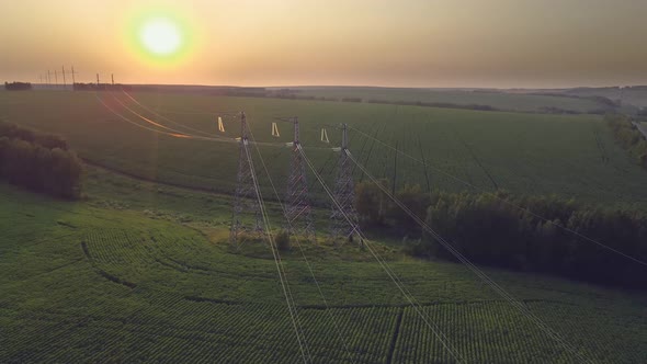 Transmission line in rural field. High-voltage tower