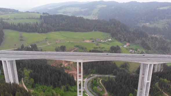 Aerial View of the Highway Viaduct on Concrete Pillars with Traffic in Mountains