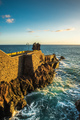 Rocks at Ponta do Sol, Madeira  beach with promenade on cliffs. Sunset light, Atlantic Ocean waves - PhotoDune Item for Sale