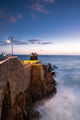 Rocks at Ponta do Sol, Madeira  beach with promenade on cliffs. Sunset light, Atlantic Ocean waves - PhotoDune Item for Sale