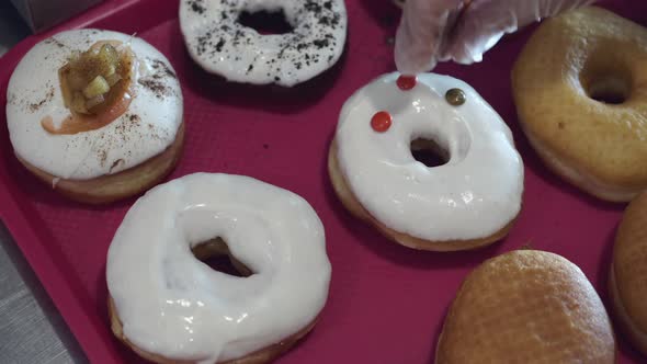 The Baked Donuts Are Being Decorated By Sweets