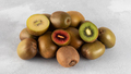 Different varieties of kiwi lie in a pile on the table. Halves of red, yellow and green kiwi. - PhotoDune Item for Sale