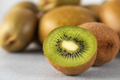 Green ripe kiwi half and whole on grey table. Place for text. Horizontal photo. - PhotoDune Item for Sale