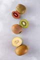 Different varieties of kiwi lie in a pile on the table. Halves of red, yellow and green kiwi. - PhotoDune Item for Sale
