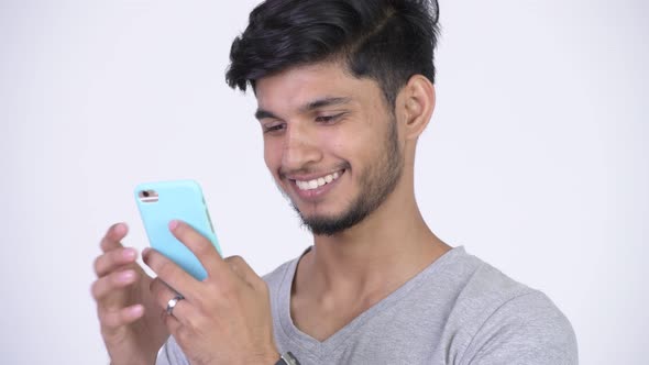 Young Happy Bearded Indian Man Using Phone