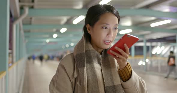 Woman use of mobile phone in city at night