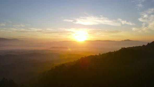 Aerial view of landscape view sunrise or sunset over mountain and misty. Beautiful nature forest