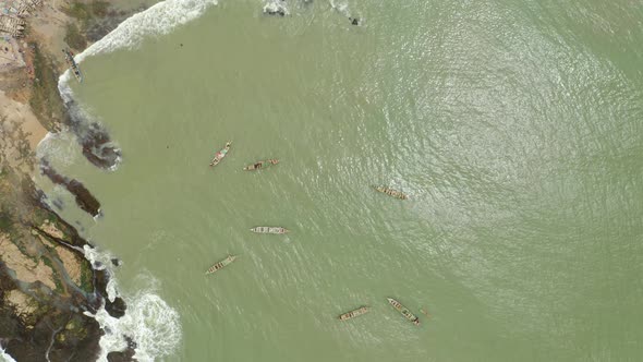 Aerial shot of a boat or canoe fishing in a sea during the day_4