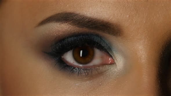 Girl with an Evening Make Up Closes and Opens the Eyes. Close Up