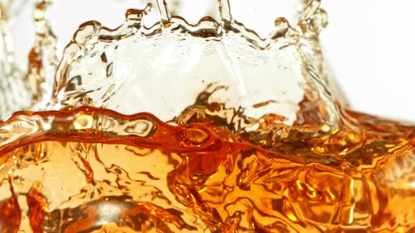 Super Slow Motion Shot of Ice Tea Splash Isolated on White Background at 1000Fps