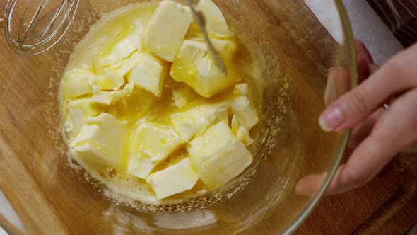 Woman Cuts Butter Into Bowl for Making Dough for Gingerbread