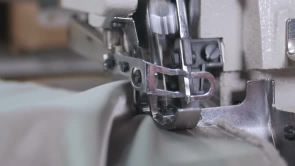 A Woman Using a Sewing Machine To Sew Fabric Together