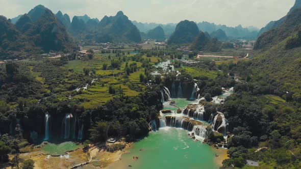 Boats floating near waterfall