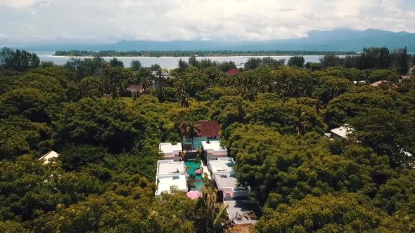 Unbelievable aerial flight fly forwards drone shot of a luxury resort flamingo hotel on a scenic tro