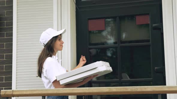 Female Courier Giving Pizza Boxes to Man