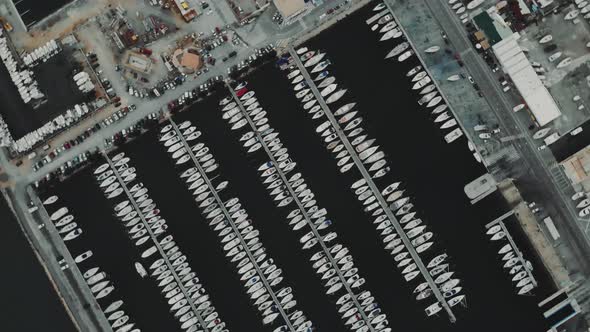 Aerial Drone Flying Out Over a Marina for Boats and Tourist Ships