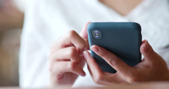 Woman use of mobile phone in the coffee shop