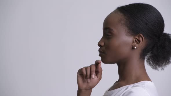 Closeup Profile View of Young Beautiful African Woman Thinking