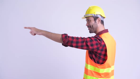 Profile View of Happy Bearded Persian Man Construction Worker Directing