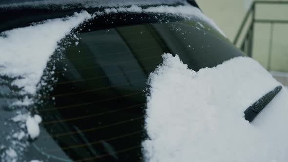 Close Up Woman Hands Cleans the Car of Snow with a Brush