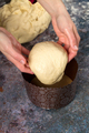 Confectioner lays the dough in form for baking Easter cakes - PhotoDune Item for Sale
