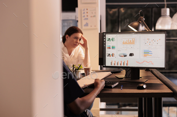 Office worker analyzing analytics report data on computer