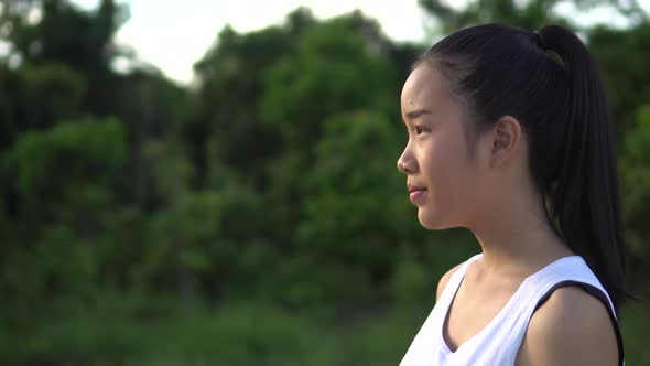 Young beautiful asian woman Jogging in the park