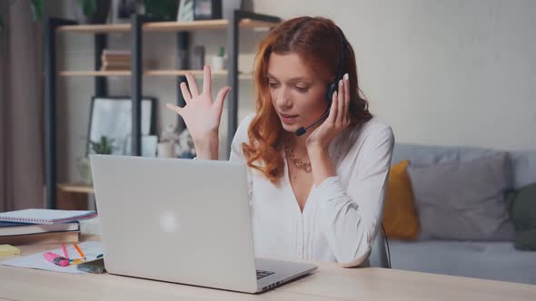 Successful Caucasian Woman in Headset with Mic Talks and Gestures with Hands