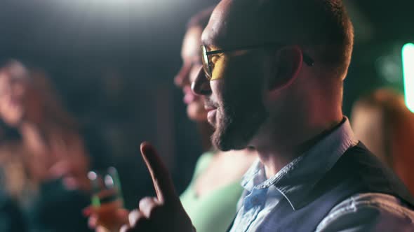 Closeup Happy Hipster Male Sunglasses Dancing at Night Club with Beer Mug Relaxing Flashing Light