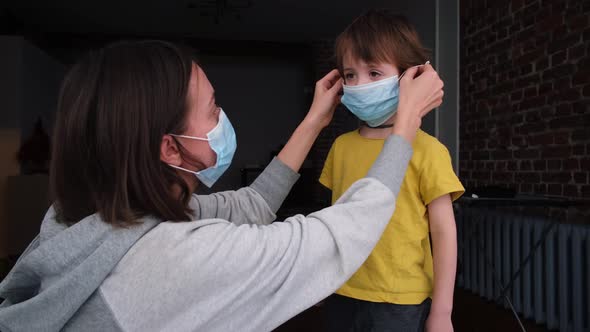 Parent Puts on a Protective Mask on Child