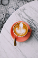 Trendy pink cup of hot cappuccino on marble table background. beautiful latte art on the top. - PhotoDune Item for Sale