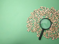 Wooden word and magnifying glass on a green background - PhotoDune Item for Sale