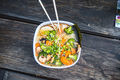 Bowl of ramen with vegetables and noodles on a wooden table. - PhotoDune Item for Sale