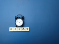 Black alarm clock with the word DELAY - PhotoDune Item for Sale