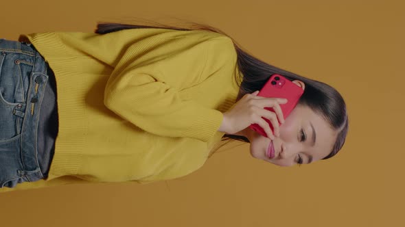 Vertical Video Asian Woman Using Smartphone to Have Phone Call Conversation