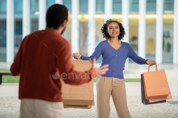  Posing With Paper Shopping Bags And Smiling Standing Outdoors. Selective Focus On Female Buyer. Shopaholism Issue Concept