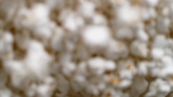 Camera follows popcorn jumping. Slow Motion. alt