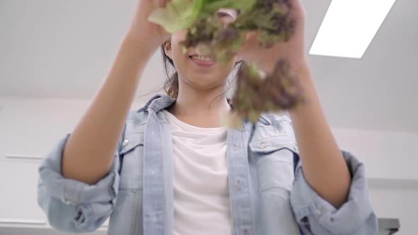 Young Asian woman making salad healthy food use organic vegetables lots.