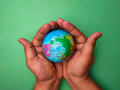 Hand holding earth globe on a green background - PhotoDune Item for Sale