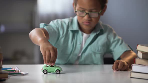 Preschooler Boy Playing with Toy Car, Dreaming About Real Auto and Traveling