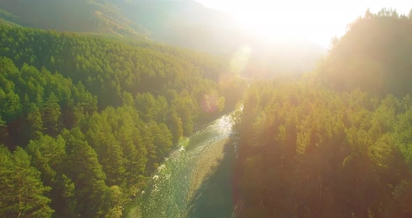 Low Altitude Flight Over Fresh Fast Mountain River with Rocks at Sunny Summer Morning