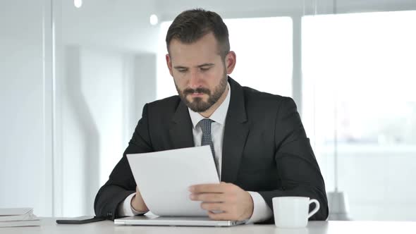 Tense Upset Middle Aged Businessman Reacting to Loss on Smartphone